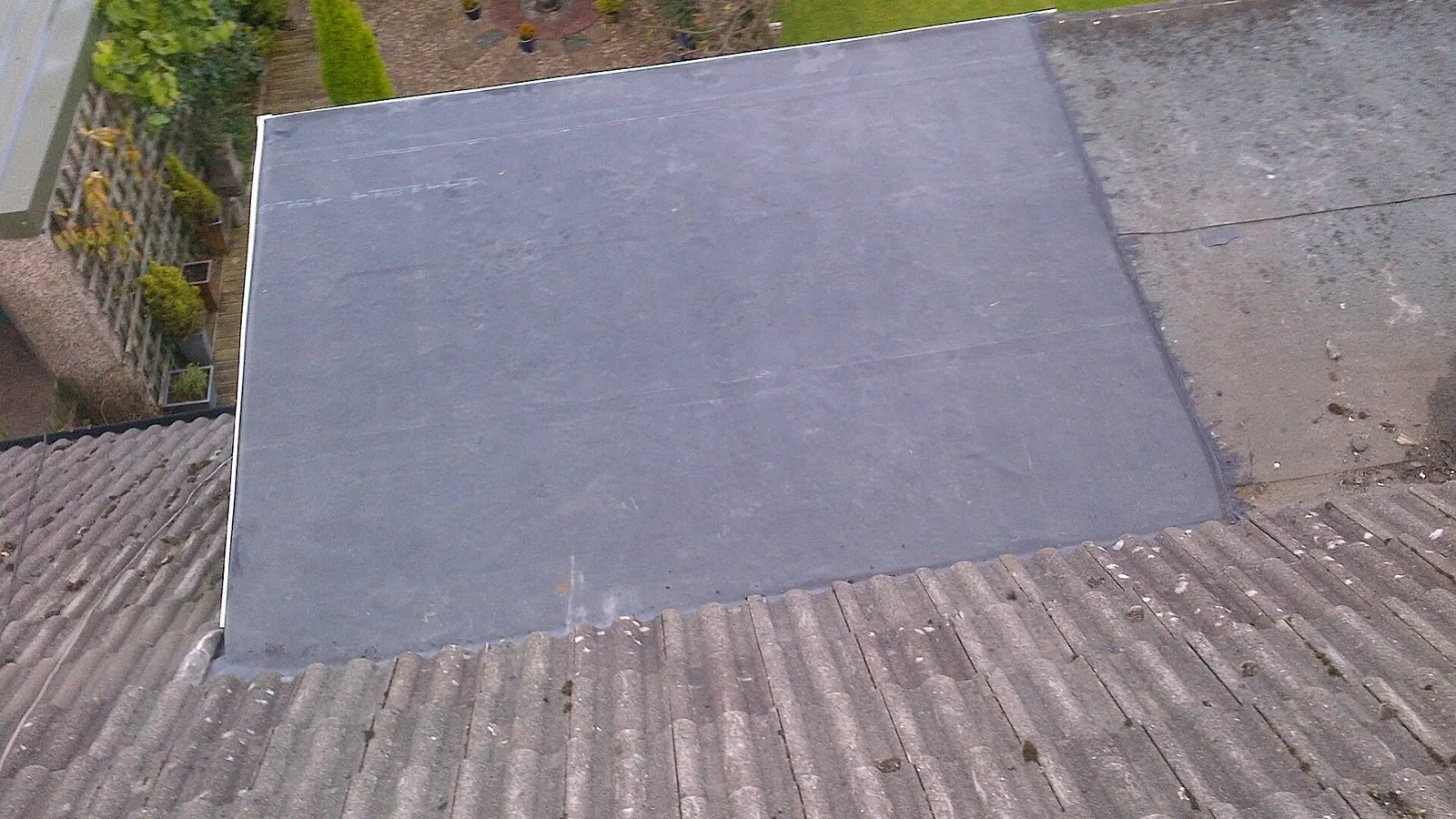 Black EPDM rubber membrane flat roof on a small extension in Halifax, England