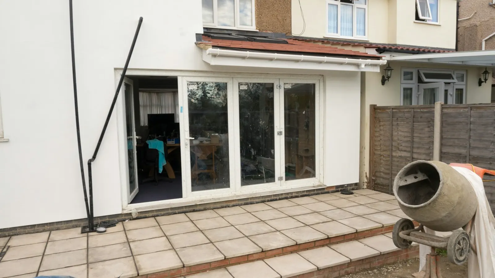 Finished single-storey rear extension with glazed folding doors on a UK semi-detached house