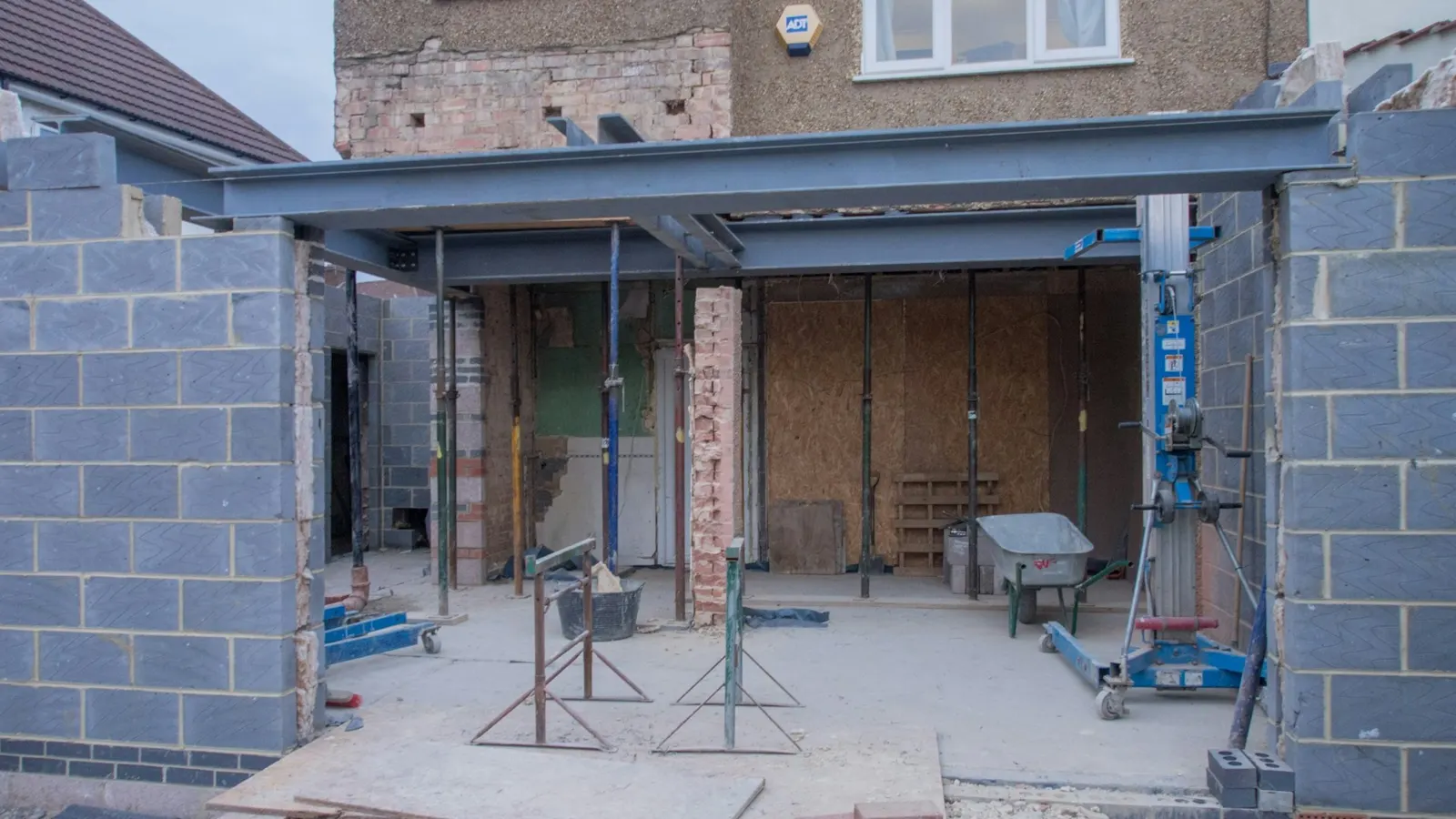 Rear extension under construction with blockwork walls and steel beam frame