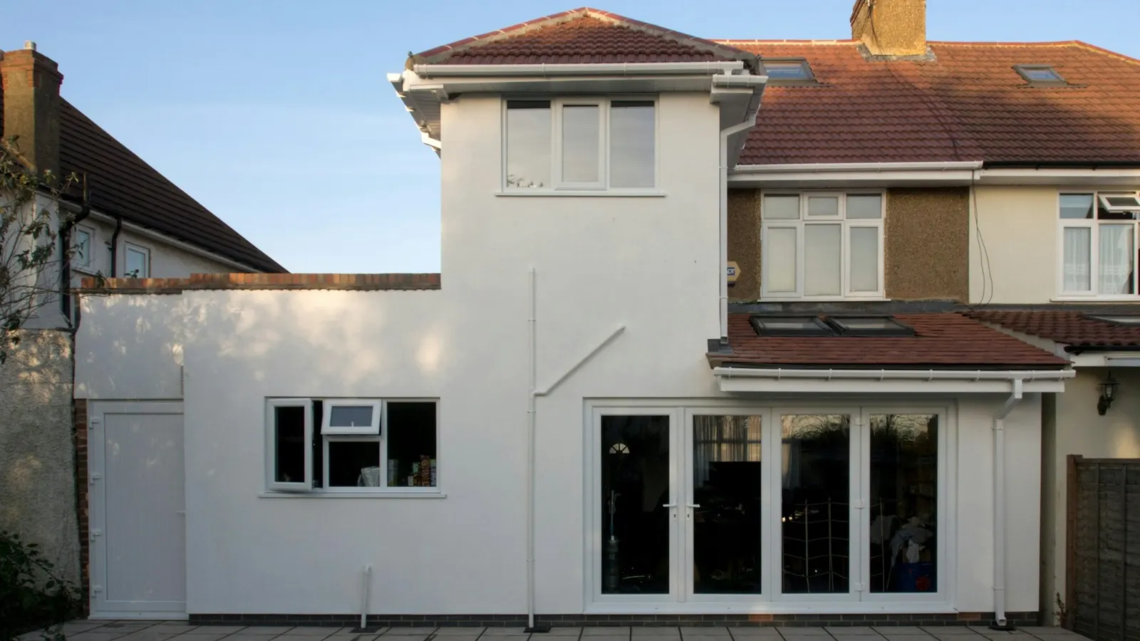 Modern single-storey rear extension with a flat roof on a UK semi-detached house