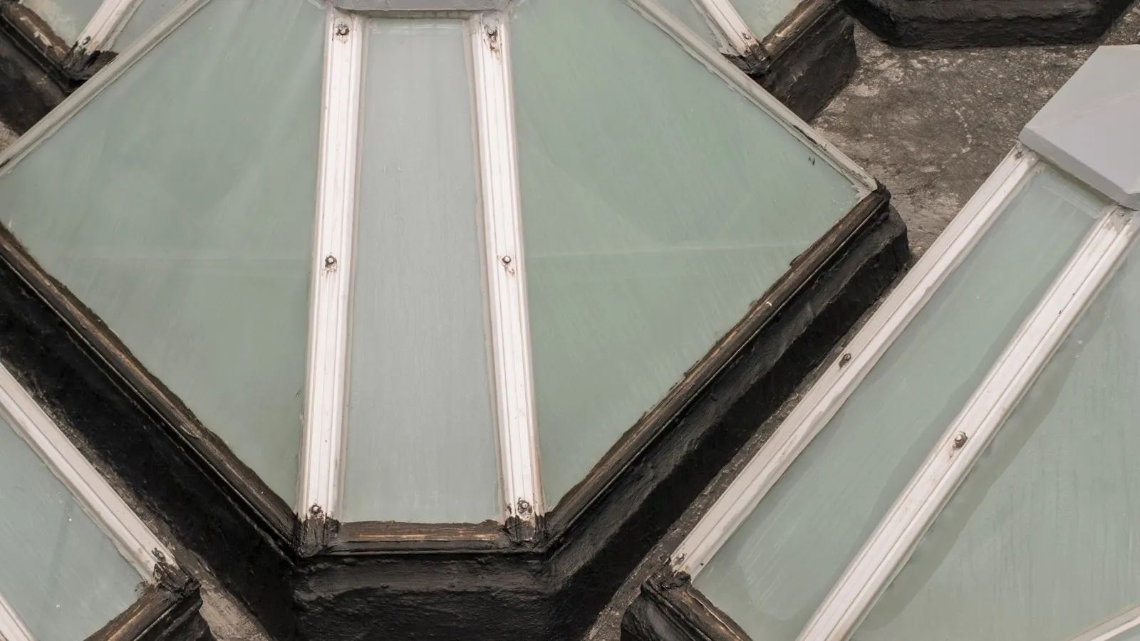 Close view of glazed pyramid rooflights set into a flat roof