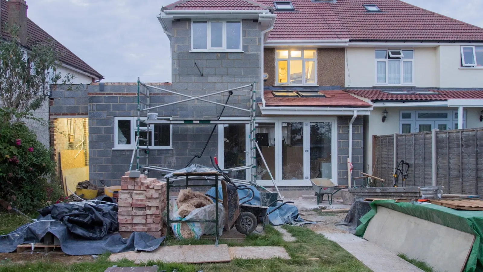Single-storey rear extension under construction on a British semi-detached house, ready for a flat roof covering