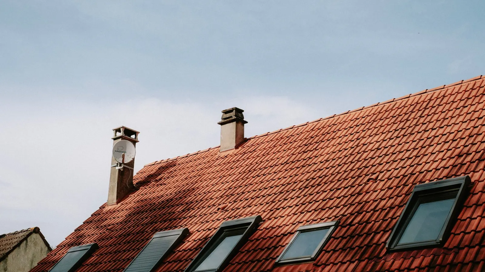 Red tile pitched roof with roof windows on a house