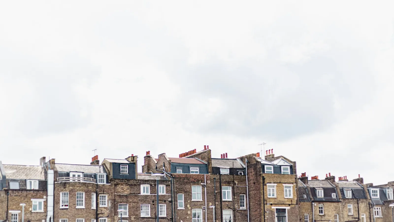 Rooflines of London Victorian terraced houses with chimney stacks and parapets